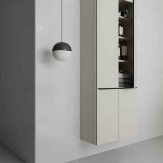 Ein minimalistischer Raum mit einem modernen, h&auml;ngenden Schrank in hellem Ton. Eine schwarze und wei&szlig;e H&auml;ngelampe erg&auml;nzt das schlichte Design.